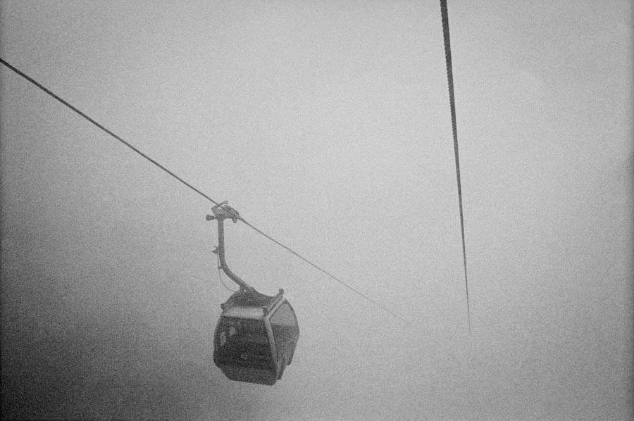 A cable car emerging from dense fog in Huangshan